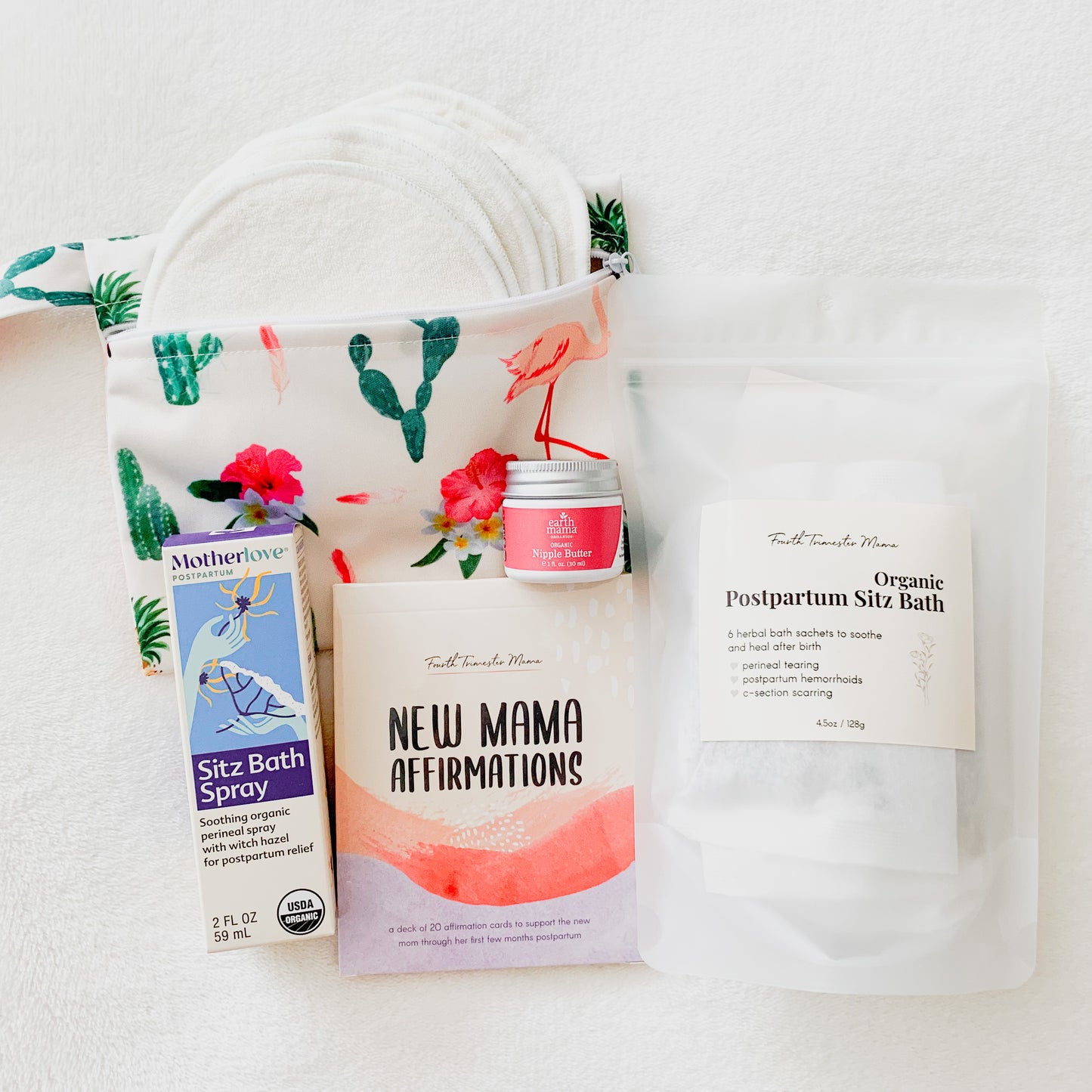 Postpartum Care Package from Fourth Trimester Mama featuring postpartum essentials including nursing pads, sitz bath, affirmation cards, nipple butter, and perineal spray