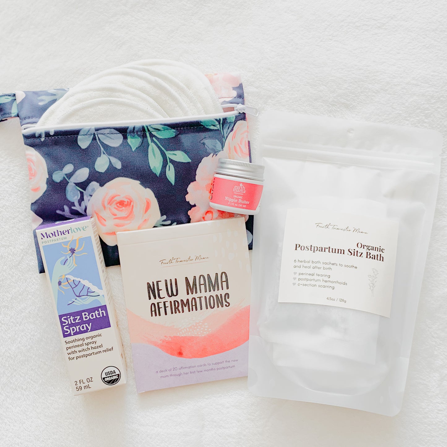 Postpartum Care Package from Fourth Trimester Mama featuring postpartum essentials including nursing pads, sitz bath, affirmation cards, nipple butter, and perineal spray