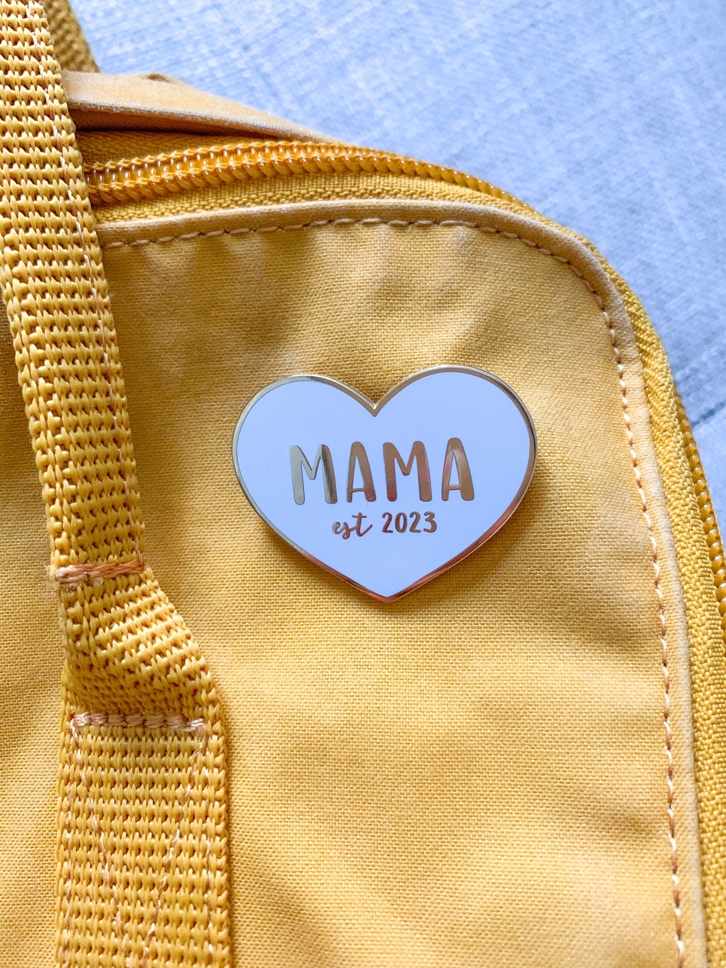 Mama enamel pin from Fourth Trimester Mama on a diaper bag