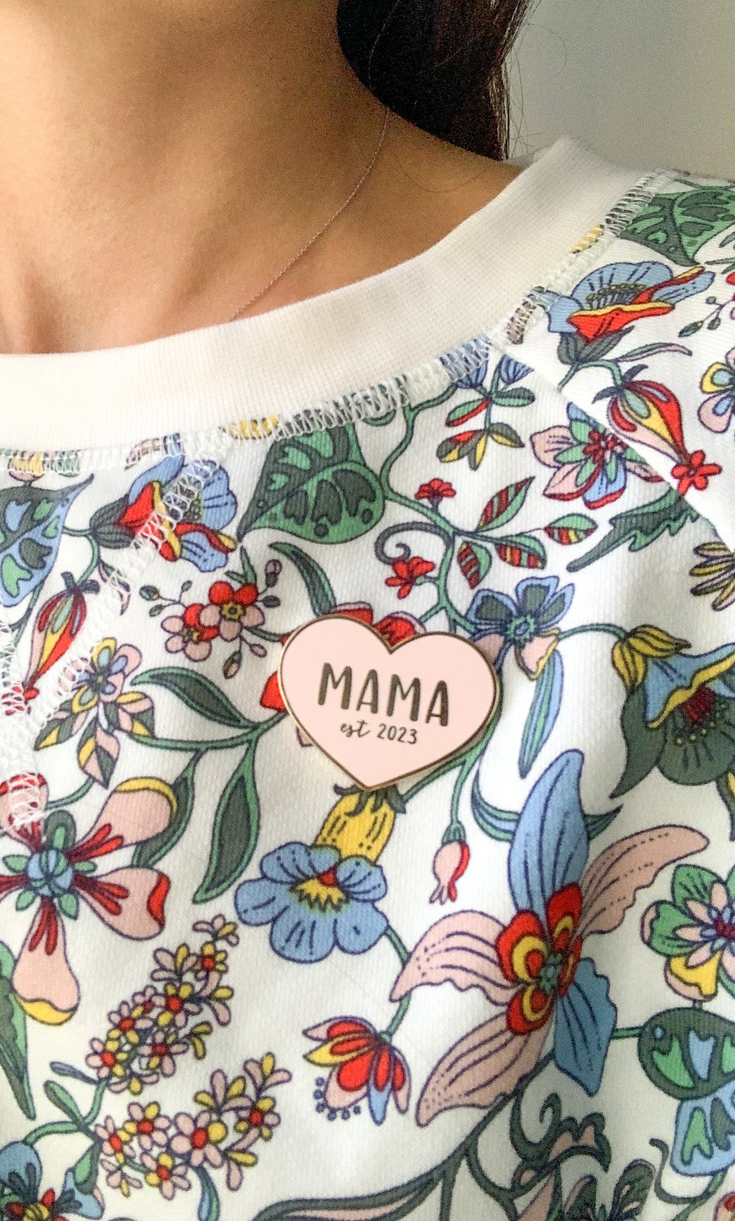 Mama enamel pin from Fourth Trimester Mama on a sweatshirt